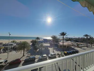 a balcony with a view of a parking lot and the beach at Maravillosa vistal'mar in Puerto de Sagunto