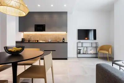 a kitchen and dining room with a table and chairs at Valencia Home Alfahuir in Valencia