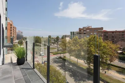 a balcony with a view of a city at Valencia Home Alfahuir in Valencia