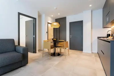 a kitchen and living room with a table and a couch at Valencia Home Alfahuir in Valencia