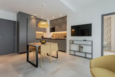 a dining room with a table and a kitchen at Valencia Home Alfahuir in Valencia