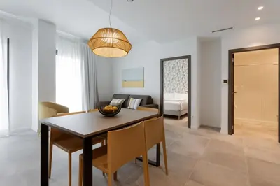 a dining room and living room with a table and chairs at Valencia Home Alfahuir in Valencia