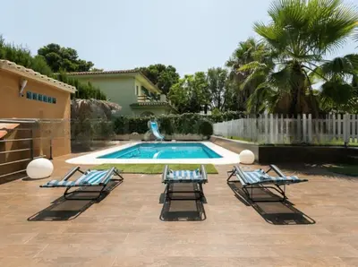 a group of lounge chairs next to a swimming pool at EXCLUSIVA CASA INDEPENDIENTE 16 ppl in Torrent