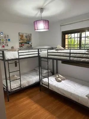 a room with three bunk beds and a light at EXCLUSIVA CASA INDEPENDIENTE 16 ppl in Torrent