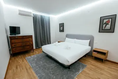 a bedroom with a large white bed and a television at Apt Almas, City Hall 1 Min, 4 Pax, Smart Tv in Valencia