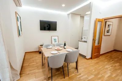 a dining room with a table and some chairs at Apt Almas, City Hall 1 Min, 4 Pax, Smart Tv in Valencia