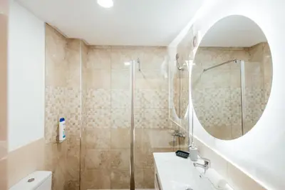a bathroom with a shower and a sink and a mirror at Apt Almas, City Hall 1 Min, 4 Pax, Smart Tv in Valencia