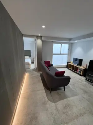 a living room with a couch and a television at Centro Histórico - Beneficencia Flat in Valencia