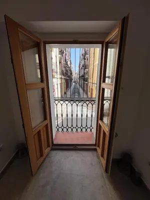 an open door to a balcony with a view of a city at Centro Histórico - Beneficencia Flat in Valencia
