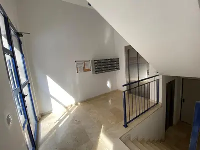 a hallway with a staircase with a window and a stair railing at Dream Moncofar in Moncófar
