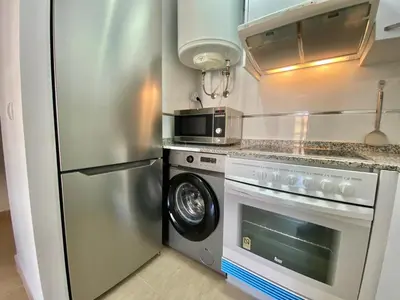 a kitchen with a stainless steel refrigerator and a microwave at Dream Moncofar in Moncófar