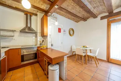 a kitchen with a table and a dining room at Valencia Flat Rental 1 bedroom apartment historical center in Valencia