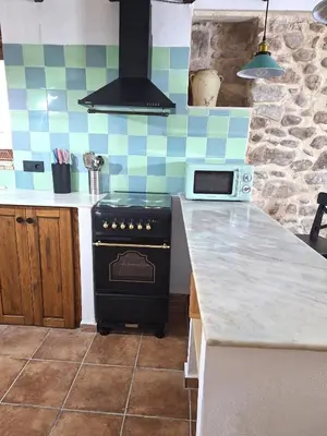 a white sink on a black counter in a bathroom at Casa Trilles in Azuébar