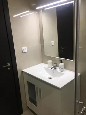 a bathroom with a white sink and a mirror at Bienvenido a Lovely Apartment, Cullera in Cullera