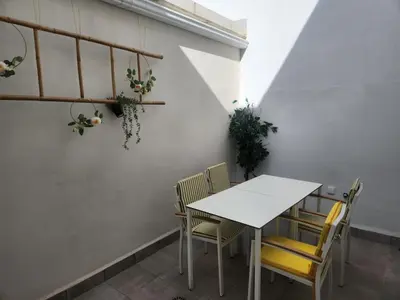 a white table and chairs in a room at Pinedo Playa Holiday in Valencia