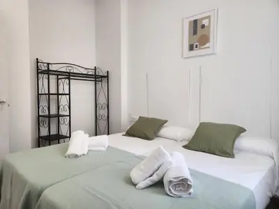 two beds sitting next to each other with towels on them at Pinedo Playa Holiday in Valencia