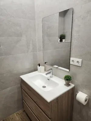 a bathroom with a sink and a mirror at Pinedo Playa Holiday in Valencia