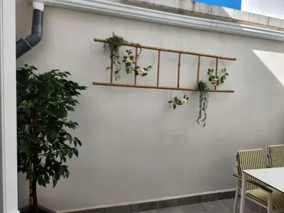 a white wall with shelves with plants on it at Pinedo Playa Holiday in Valencia