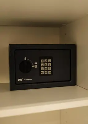 a black microwave on a shelf in a kitchen at Canoa Studio Valencia in Valencia