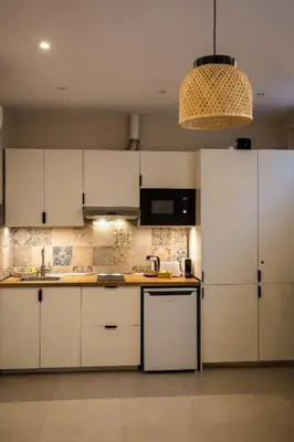 a kitchen with a sink and shelves with dishes at Canoa Studio Valencia in Valencia
