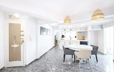 a kitchen and dining room with a table and chairs at Marisol Molina in Sueca