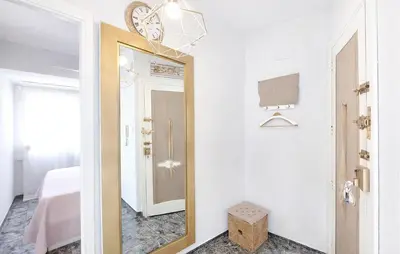a hallway with a mirror and a bed at Marisol Molina in Sueca