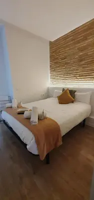 a small bedroom with a bed with two pillows at Habitaciones VIP en Vivienda Lujo Muy Céntrica in Valencia