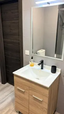a bathroom with a sink and a mirror at Apartamento con piscina, playa y cerca de Valencia in Puebla de Farnals