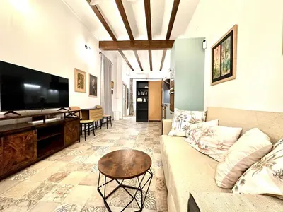 a living room with a couch and a tv at Season apartment Cabañal in Valencia
