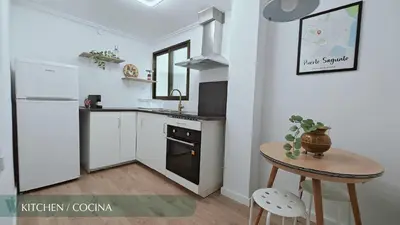 a bedroom with a bed with a green comforter at Guest Ready - Beachside Flat in Puerto de Sagunto in Puerto de Sagunto