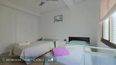 a bathroom with a shower with a mirror and a chair at Guest Ready - Beachside Flat in Puerto de Sagunto in Puerto de Sagunto