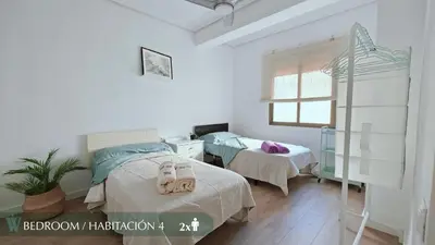 a living room with a couch and a table and chairs at Guest Ready - Beachside Flat in Puerto de Sagunto in Puerto de Sagunto