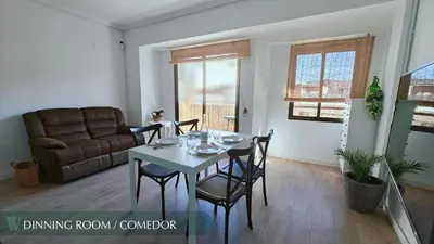 a kitchen with a blue cabinet and two chairs at Guest Ready - Beachside Flat in Puerto de Sagunto in Puerto de Sagunto