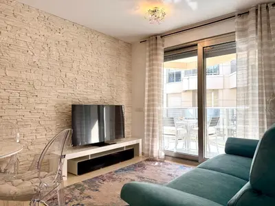 a living room with a couch and a tv at Reinapart Patacona Beach Sunrise in Valencia