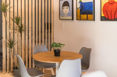 a dining room with a wooden table and chairs at Loft Sayulita Escapada moderna en el paraíso in Torrent