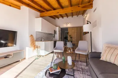 a living room with a couch and a table at Loft Sayulita Escapada moderna en el paraíso in Torrent