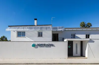 a white building with a sign on the side of it at Loft Sayulita Escapada moderna en el paraíso in Torrent