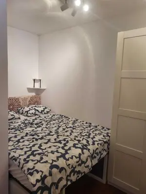 a bedroom with a bed with a black and white comforter at Piso con terraza en Cabanyal in Valencia