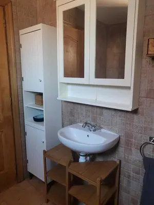 a bathroom with a sink and a cabinet at Piso con terraza en Cabanyal in Valencia
