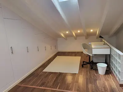 an attic room with a desk and a table at Precioso apartamento en casa histórica en la playa in Valencia