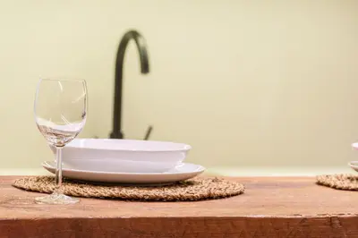 a glass of wine sitting next to a sink at GMG Apartments & Suites in Valencia