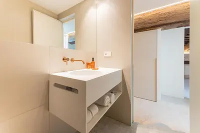 a bathroom with a white sink and a mirror at GMG Apartments & Suites in Valencia