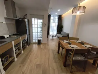 a living room with a table and a kitchen and a living room at estudio en El Castell in Burjasot
