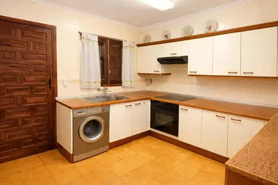 a kitchen with a sink and a washing machine at Winahost Casita Tavernes de Valldigna in Tavernes de Valldigna