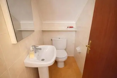 a small bathroom with a toilet and a sink at Winahost Casita Tavernes de Valldigna in Tavernes de Valldigna