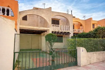 a house with a gate in front of it at Winahost Casita Tavernes de Valldigna in Tavernes de Valldigna