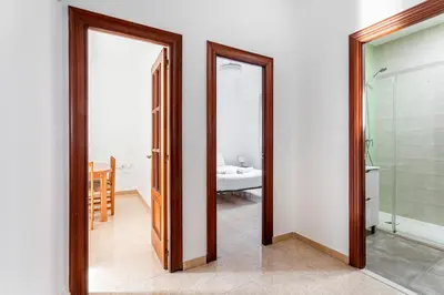 a bathroom with two mirrors and a bathroom with a sink at Guest Ready - Bright flat well‑located urban stay in Valencia