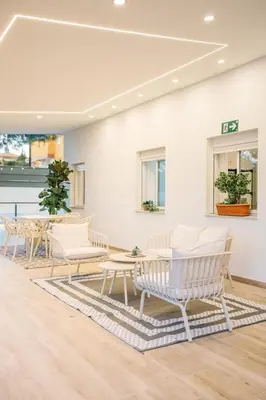 a room with white chairs and a table and a table and benches at Estrella Maya Escapada Tranquila con encanto único in Torrent
