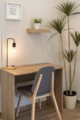 a wooden desk with a chair and a potted plant at Estrella Maya Escapada Tranquila con encanto único in Torrent