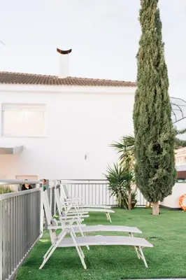 a patio with a table and chairs on the grass at Estrella Maya Escapada Tranquila con encanto único in Torrent
